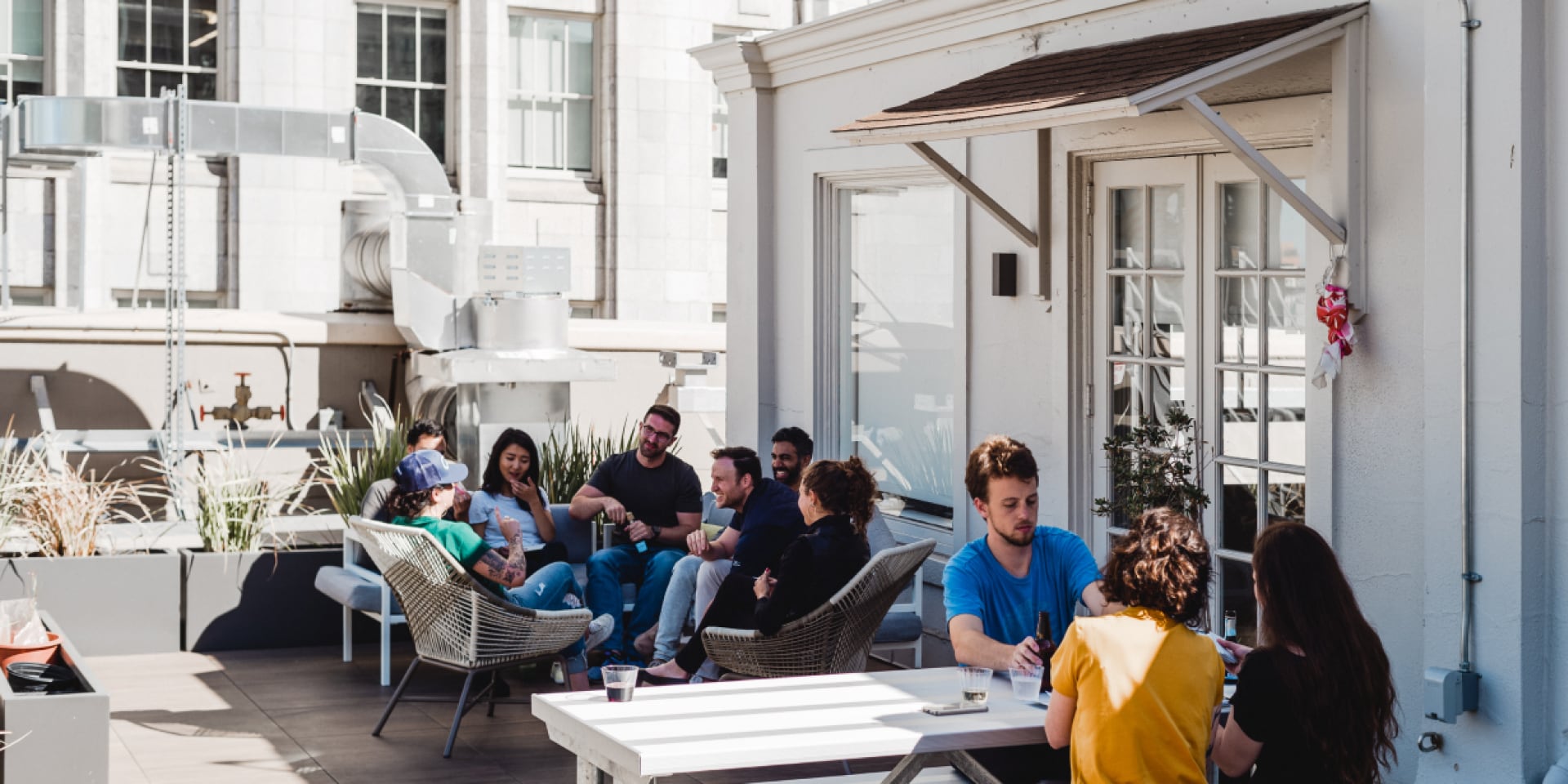 people enjoying drinks on a rooftop bar 